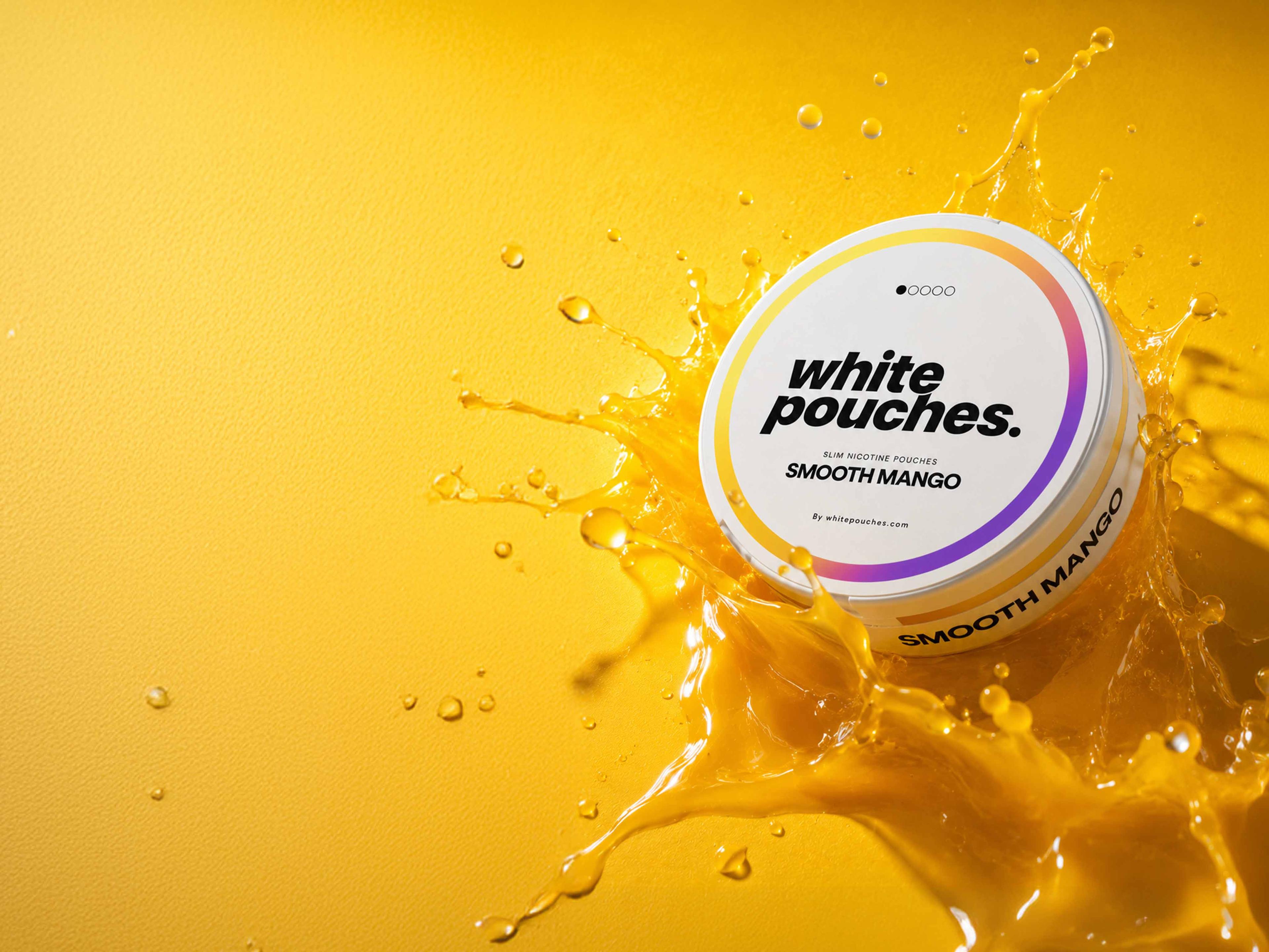 White Pouches Smooth Mango container splashing in yellow liquid on a matching background, highlighting the brand and flavor.