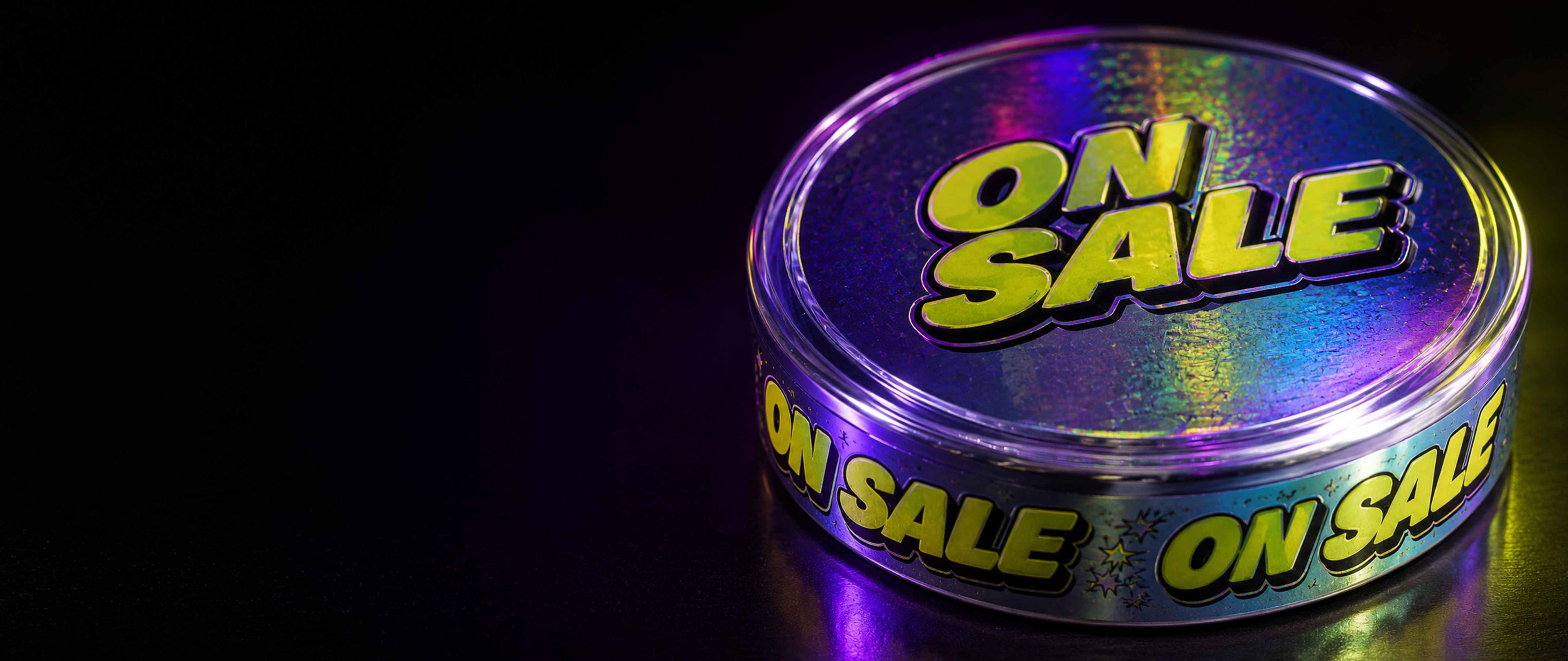 Round container with a holographic label displaying "ON SALE" in bold yellow letters, against a dark background.