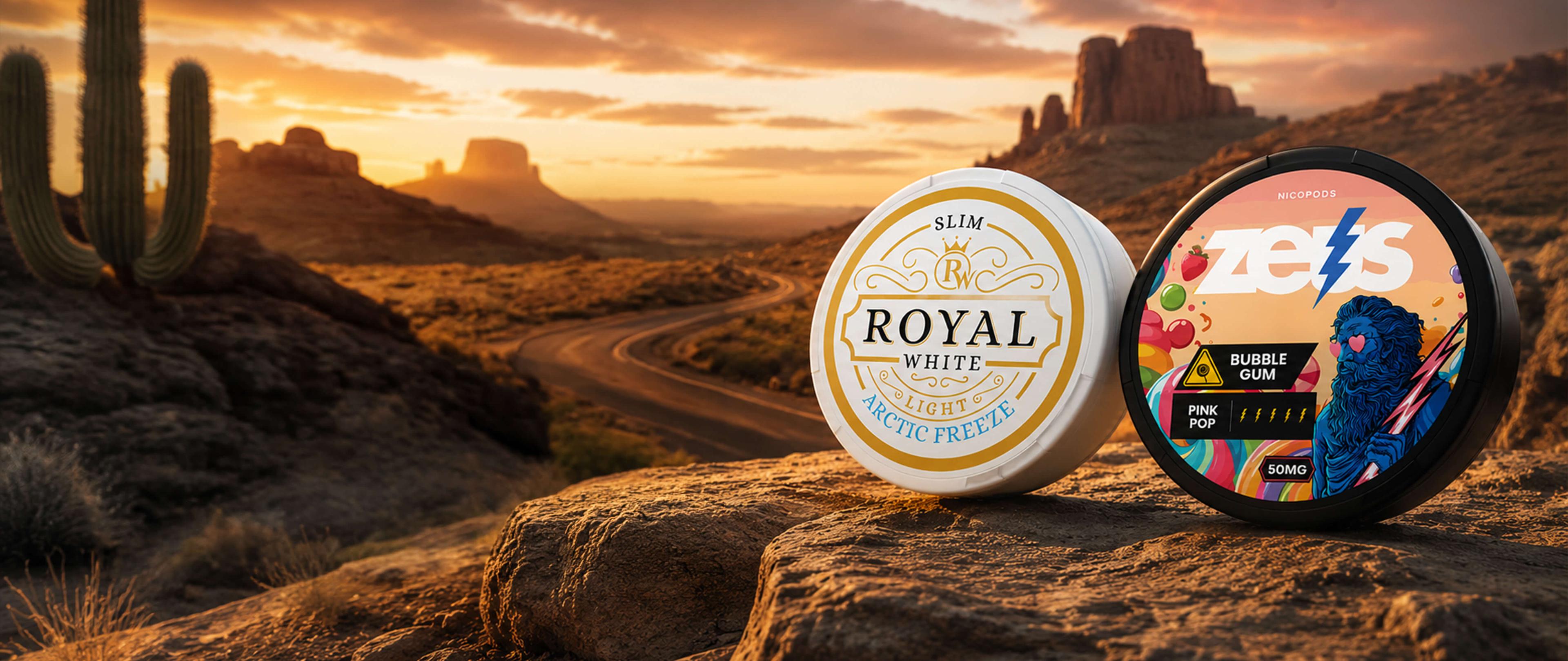 Two containers labeled "Royal White" and "Zyns Bubble Gum" on a rock with a desert sunset and cactus in the background.