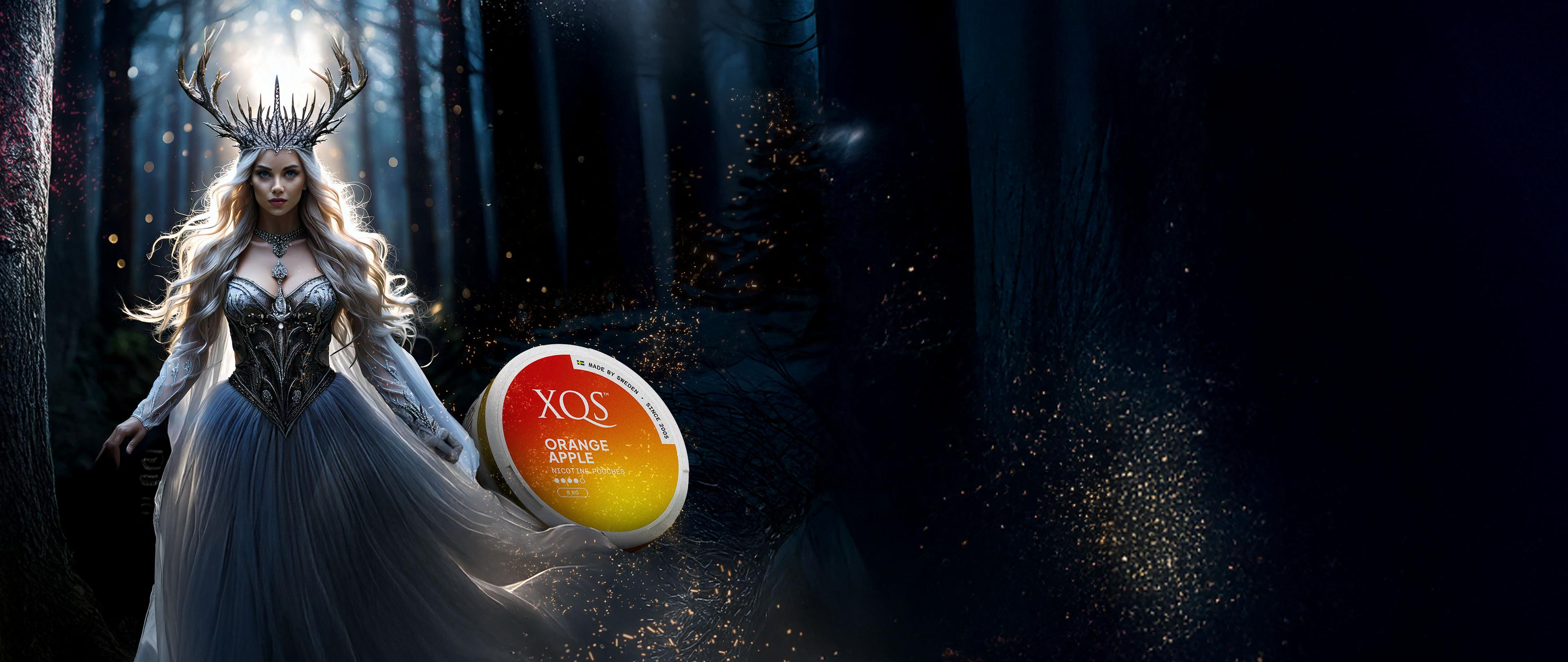 A mystical woman in a flowing gown and antler crown stands in a dark forest, next to a glowing XQS Orange Apple product.