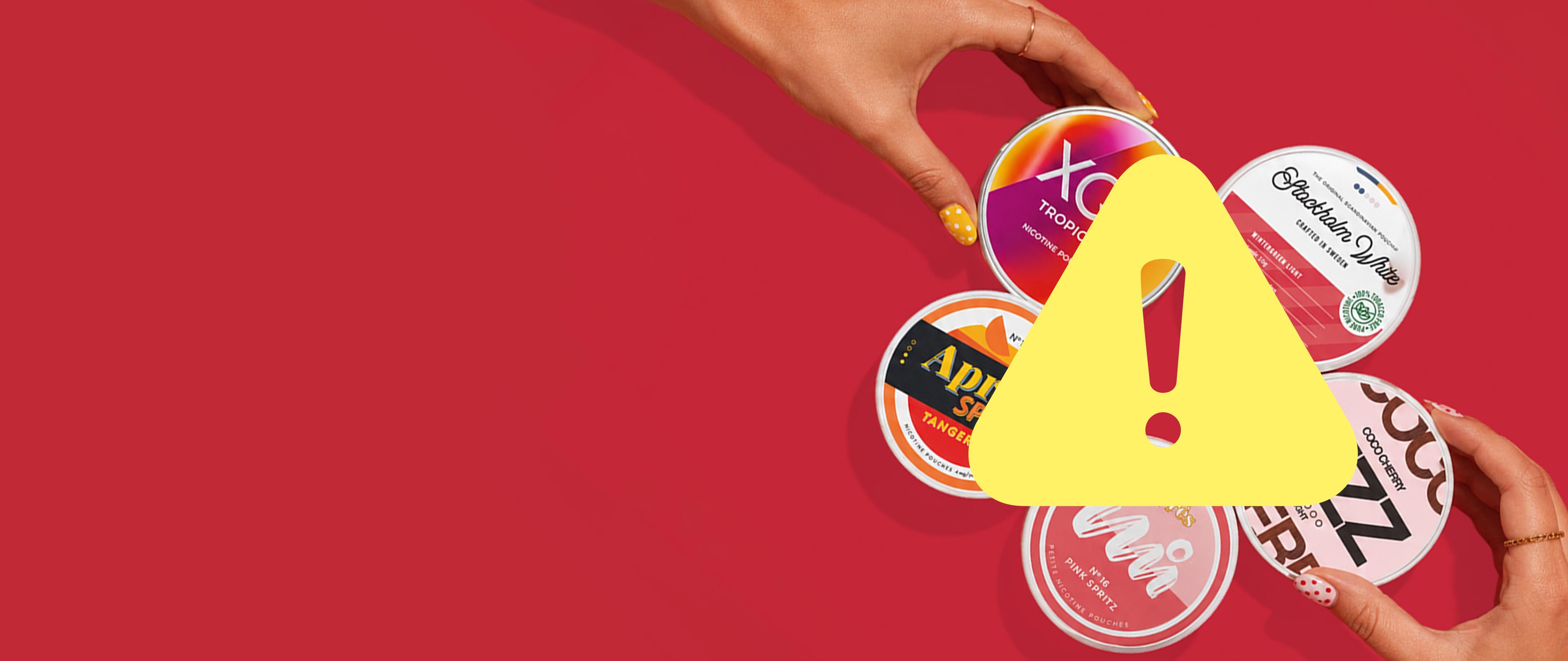 Two hands hold various nicotine pouch tins against a red background, with a yellow warning triangle in front.