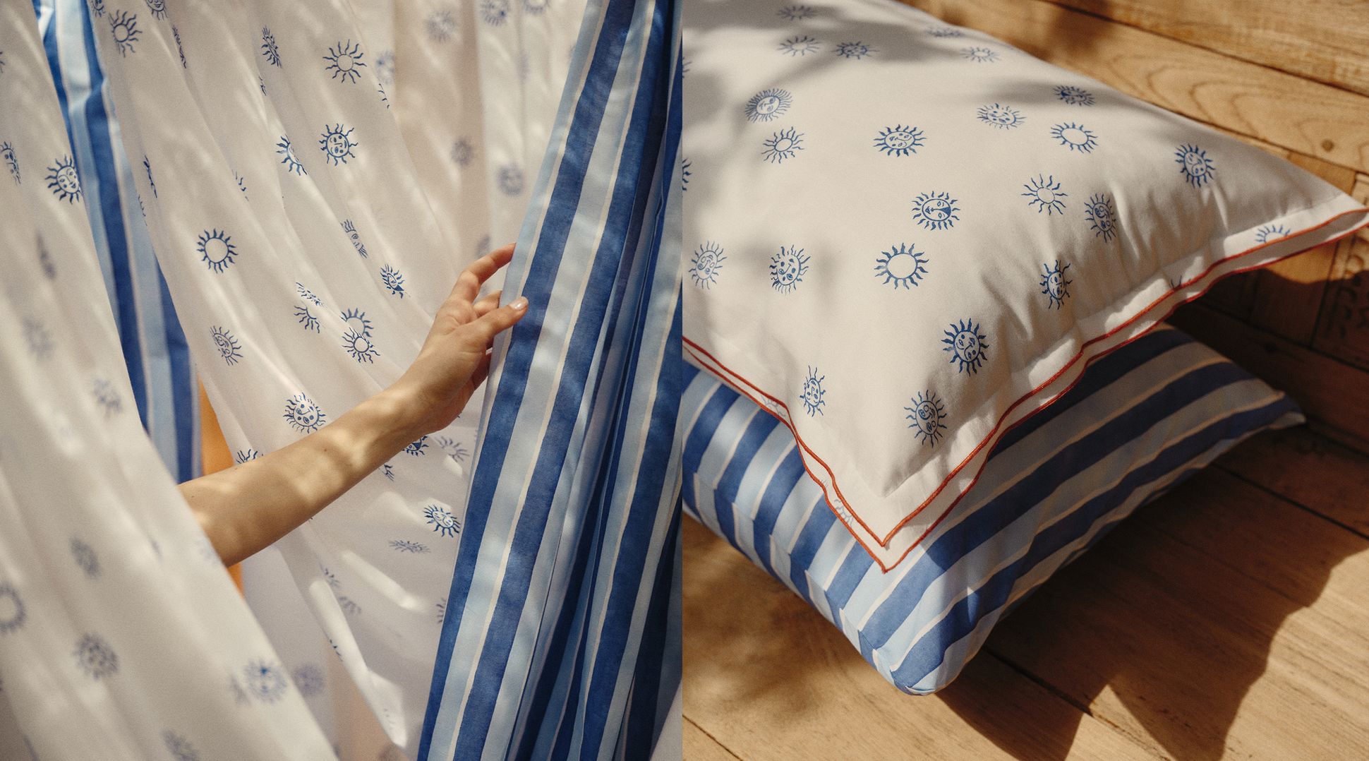 Une main tenant un tissu à rayures bleues, à côté de rideaux et de coussins ornés de motifs solaires, sur un sol en bois.