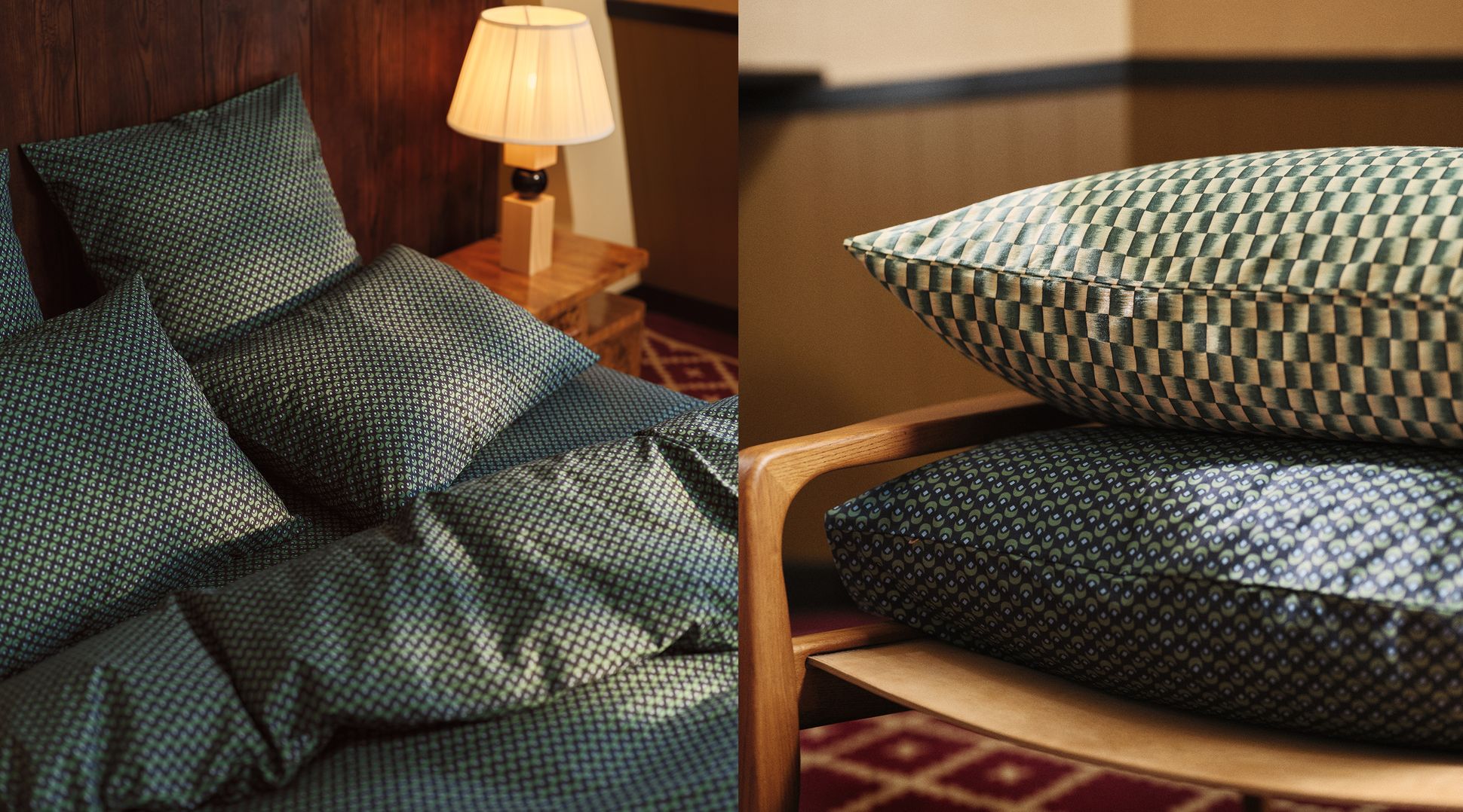 Green patterned bedding and pillows on a bed with a wooden bedside table and lamp; similar cushions stacked on a wooden chair.
