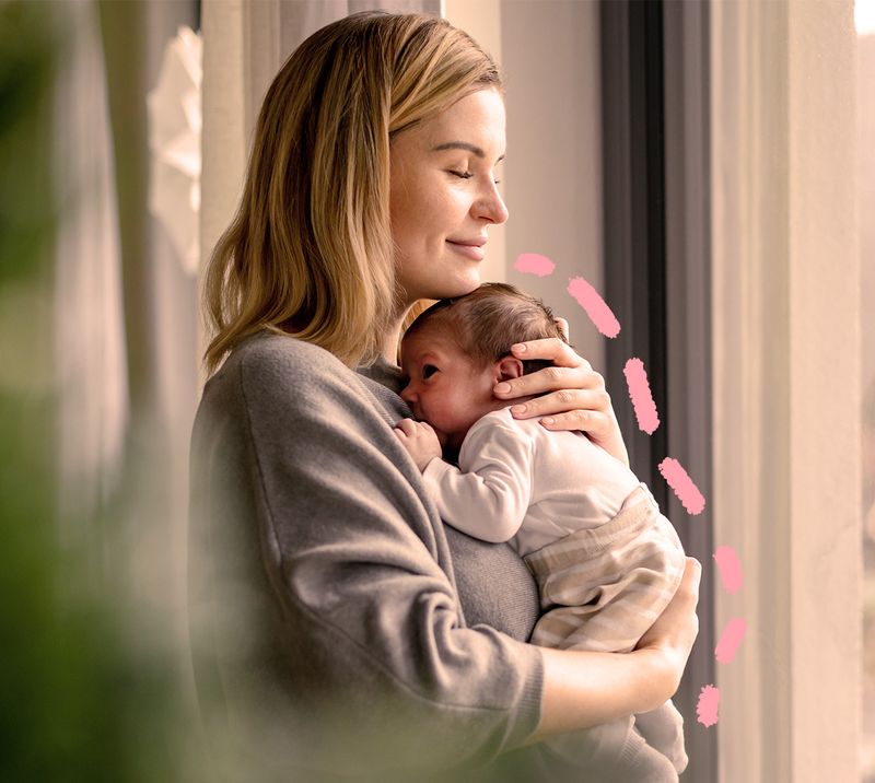 Immagine correlata al testo mamma tiene in braccio un neonato sorridente