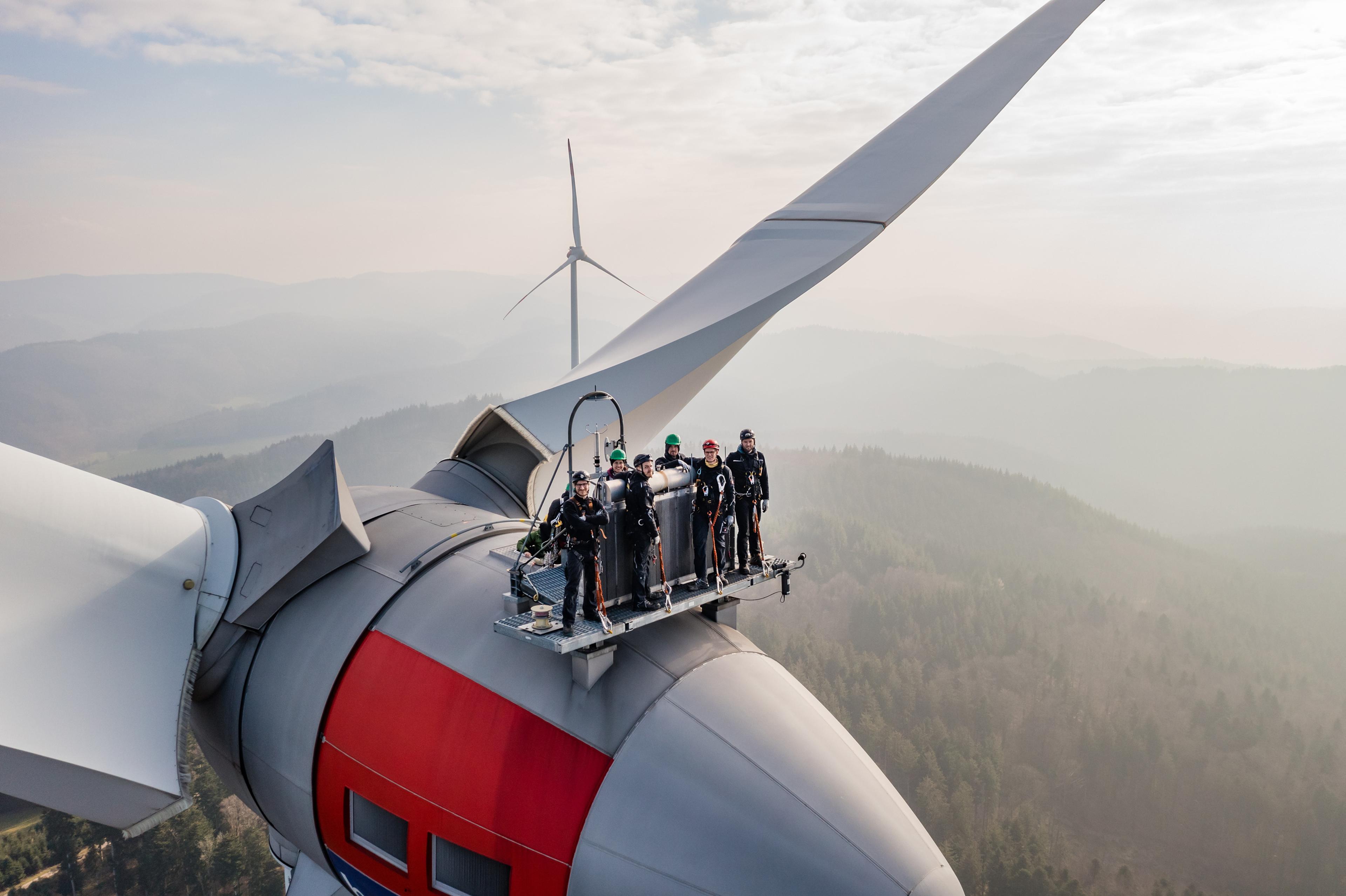 Personen auf einem Windrad im Schwarzwald