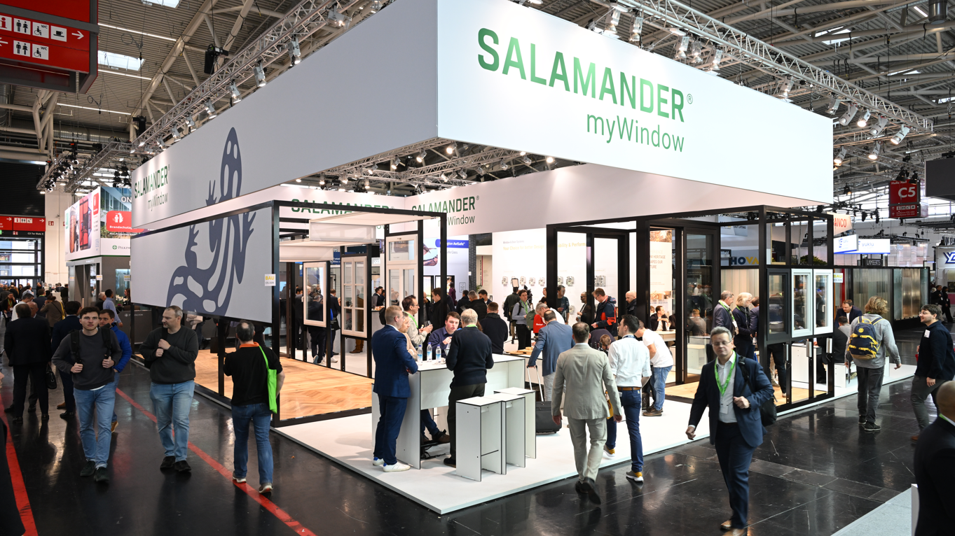 Uma grande multidão de pessoas está reunida em torno de uma barraca com uma grande placa que diz "Salamander myWindow".