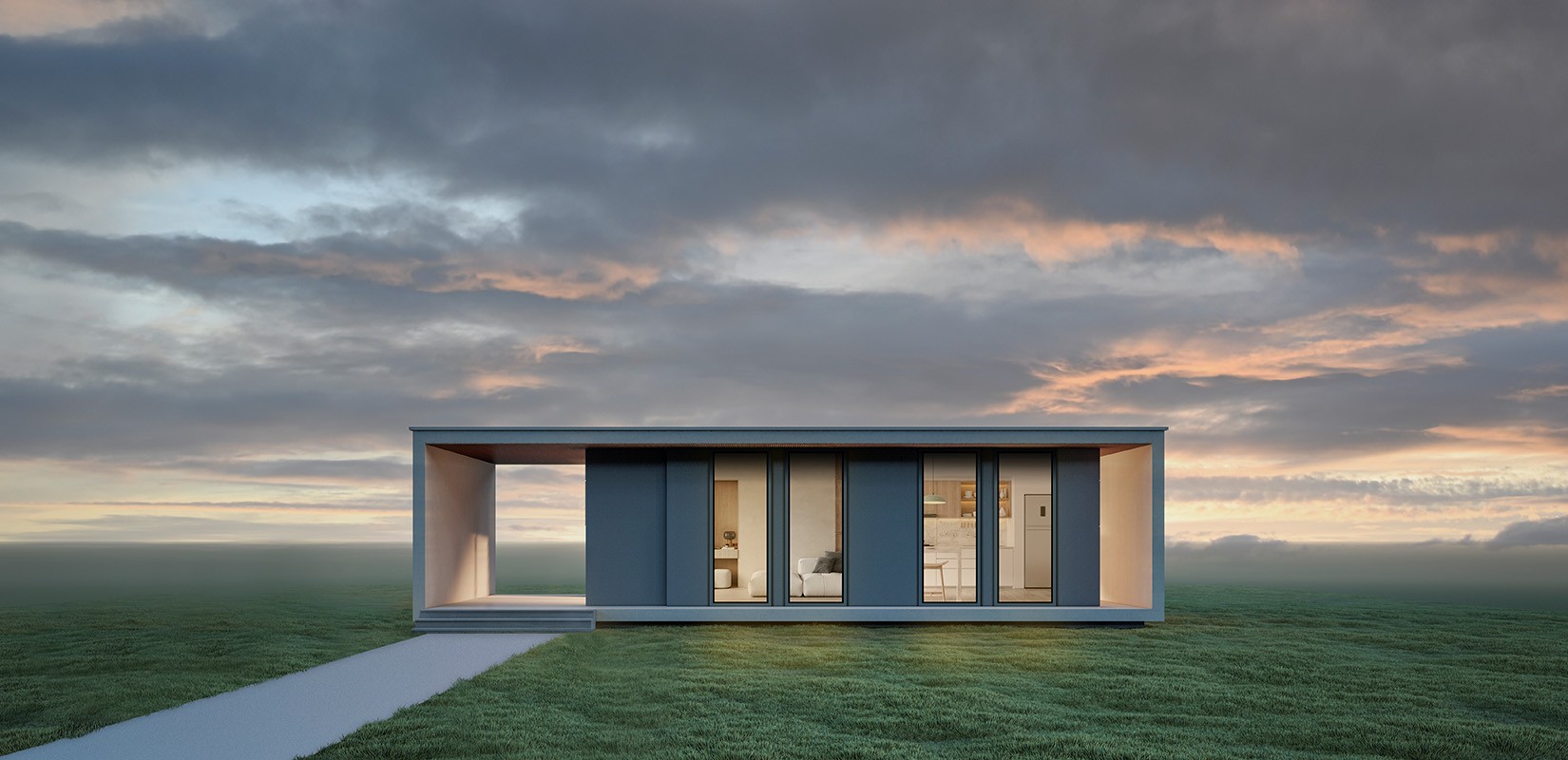 Modern rectangular house with large windows, flat roof, and a minimalist design on a grassy field under a cloudy sunset sky.