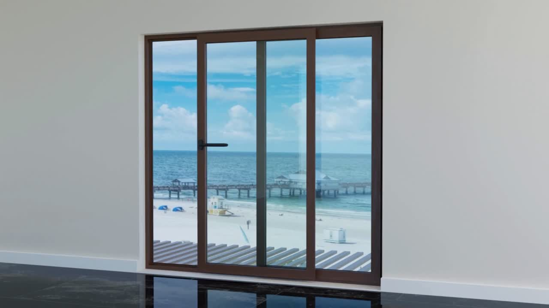 Sliding glass door with a view of the beach and ocean, framed by a brown frame and set against a white wall.