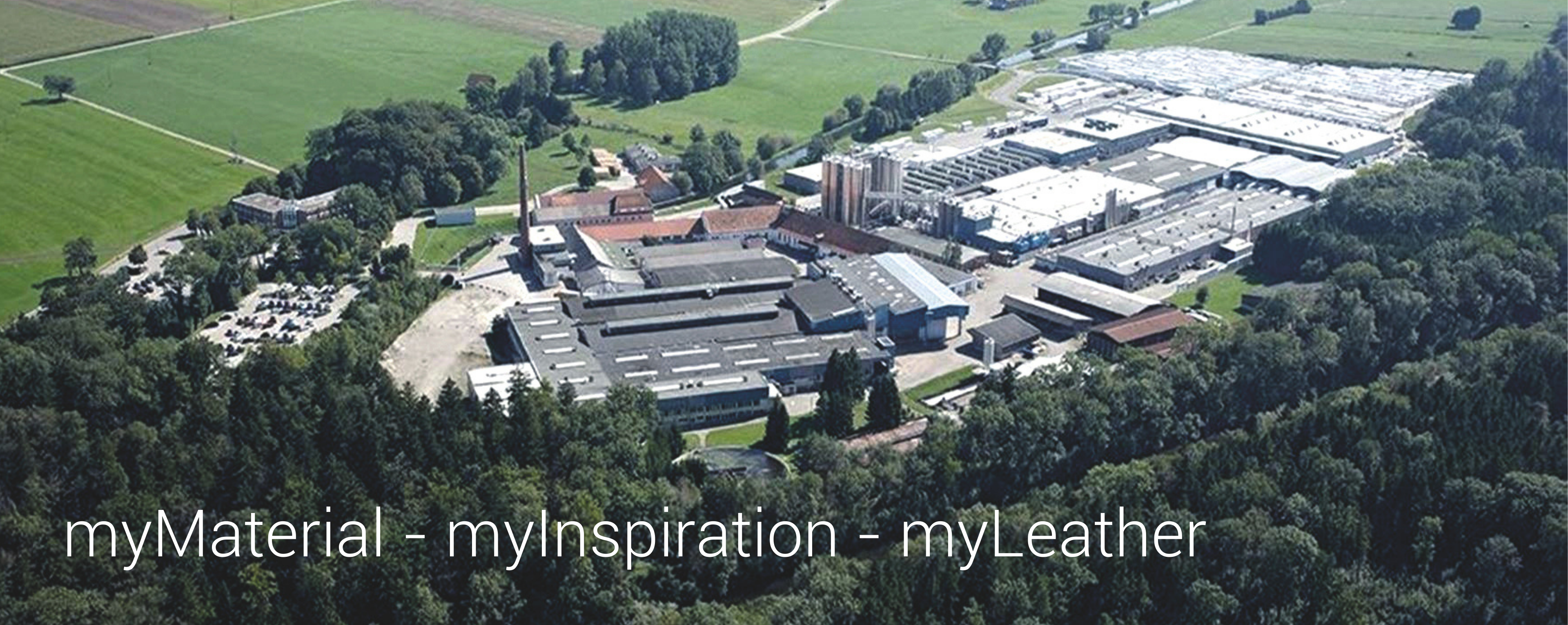 An aerial view of a large industrial complex surrounded by green fields and trees, with the text "myMaterial - myInspiration - myLeather" prominently displayed.