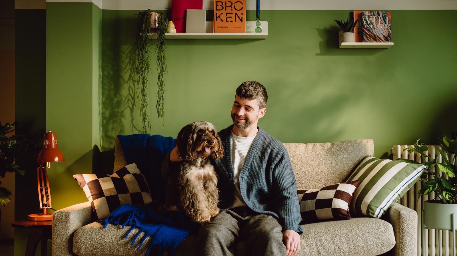 Man sitting on sofa with dog - new apartments for rent in Walthamstow