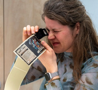Sanne packaging technologist checking label through a loop