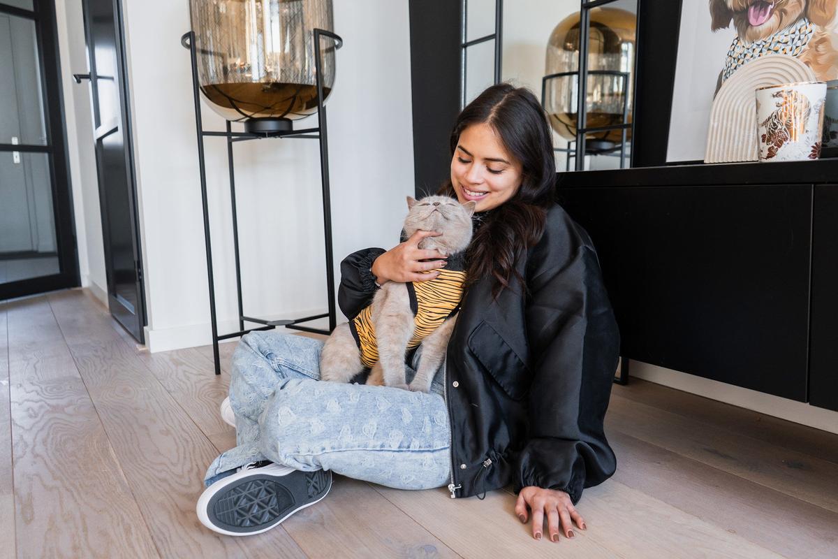 Woman petting cat recovery suit suitical