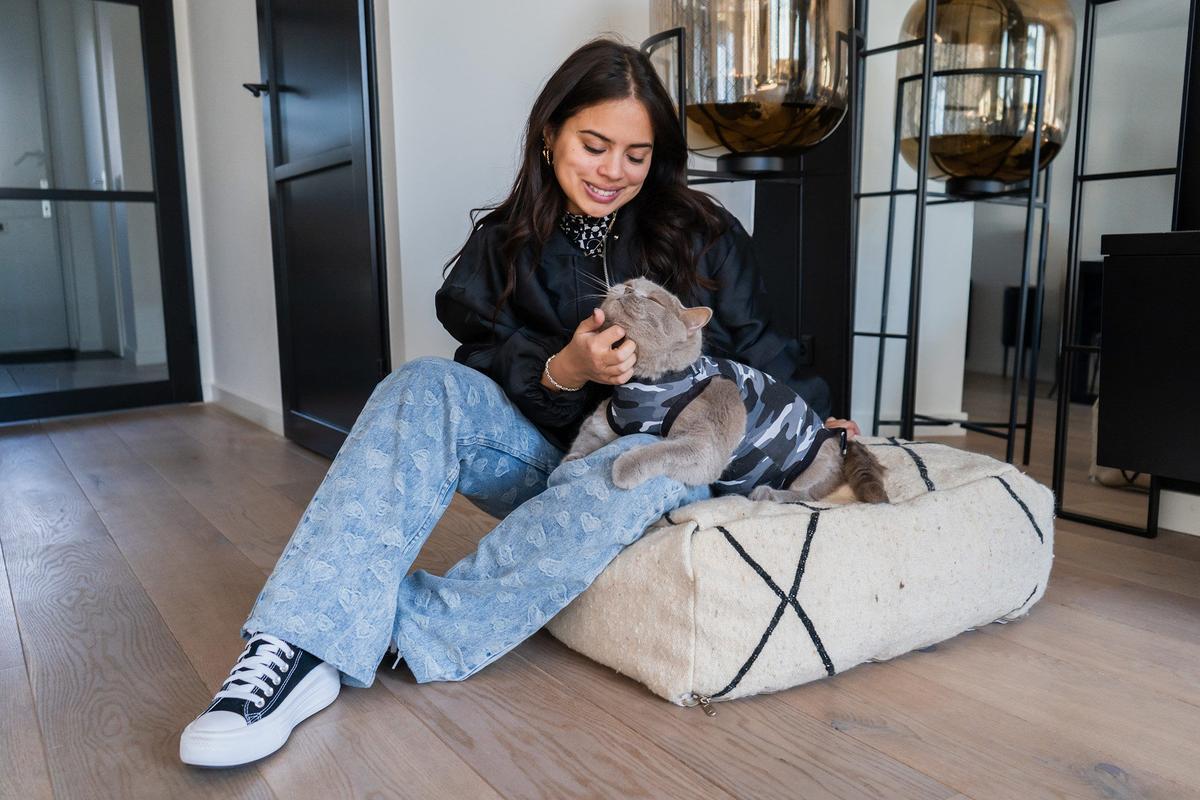 Woman petting cat recovery suit suitical