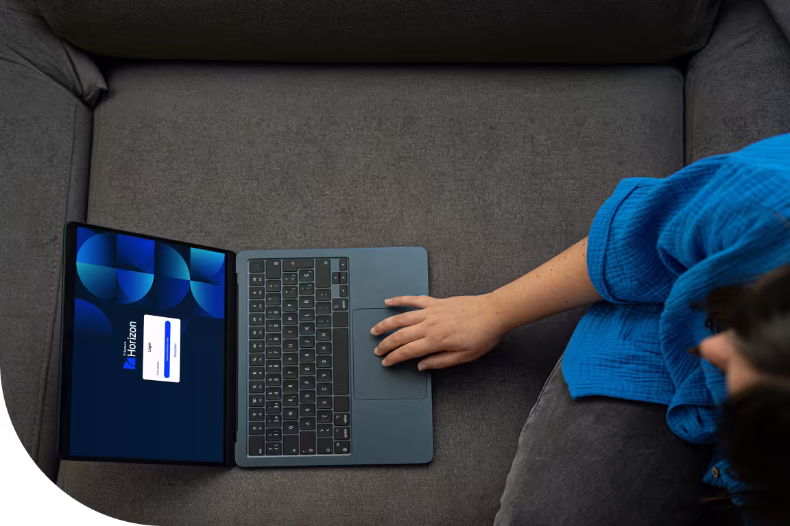 Woman using a laptop on a sofa