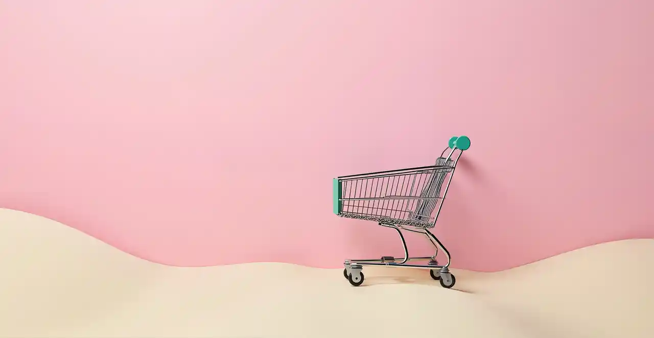 Carrito de compra vacío sobre fondo rosa, representando el abandono de carritos en ecommerce.
