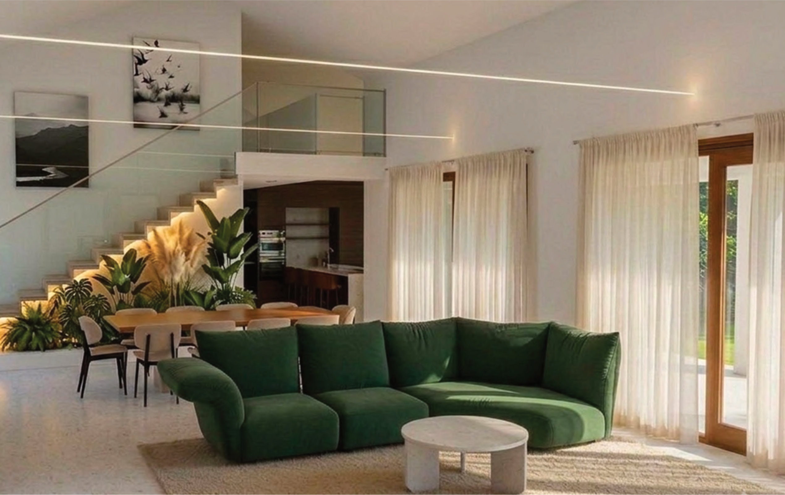 Spacious modern living room with a green sofa, large windows, sheer curtains, indoor plants, a dining table, and staircase leading to a second floor.