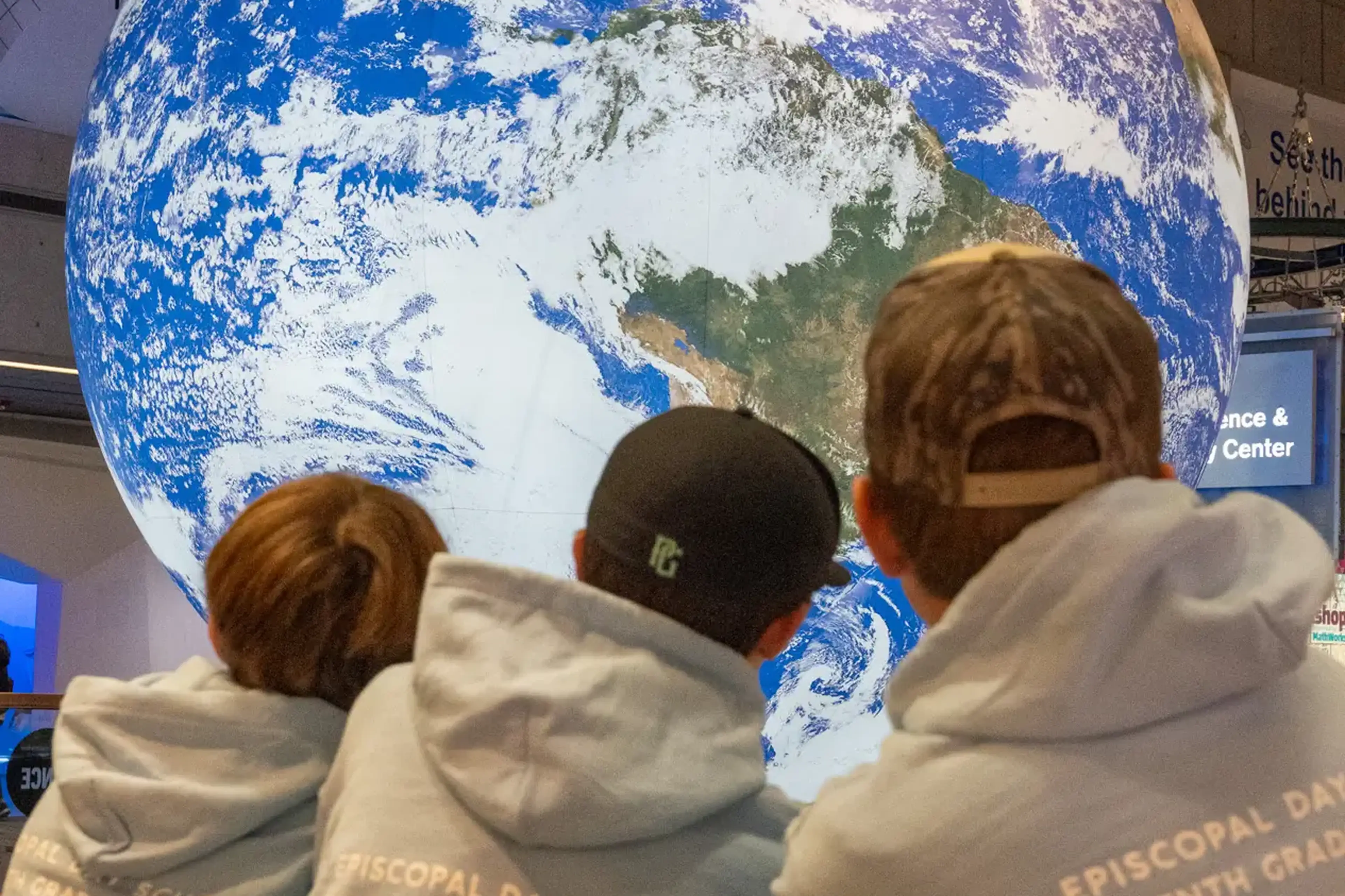 three students at space museum exhibit