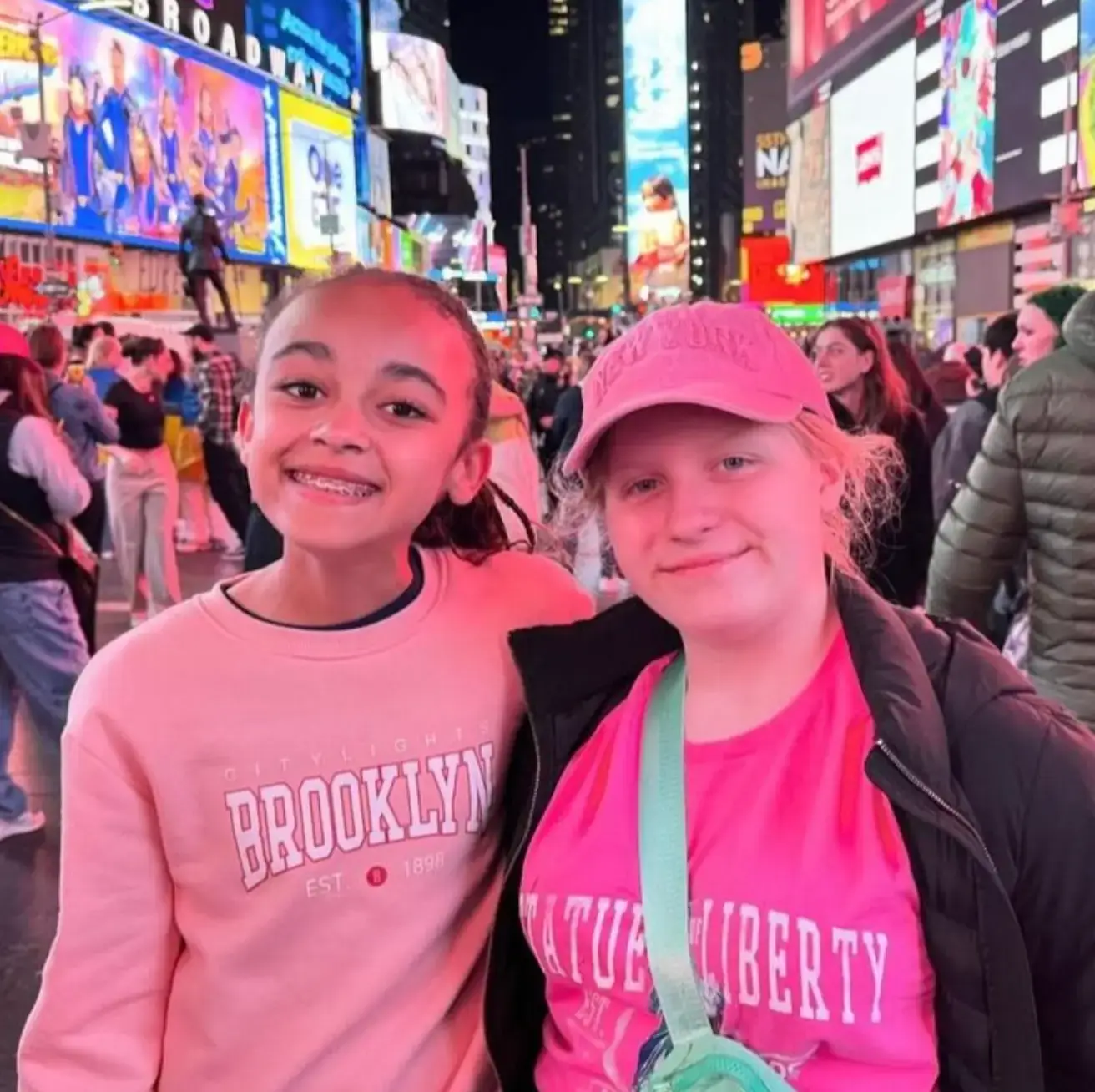 Travelers smiling at Times Square