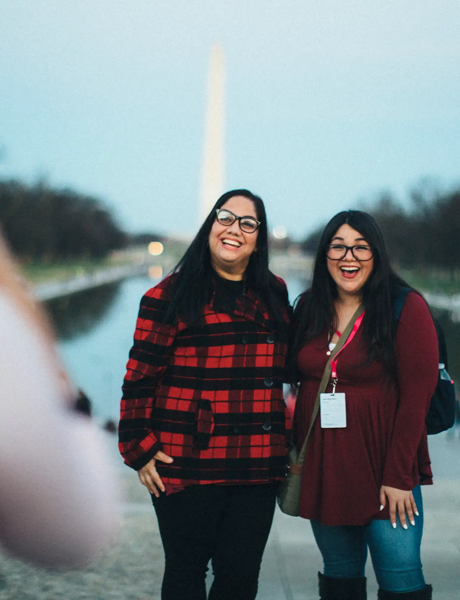Two teachers taking a photo in front of the Washington Monument