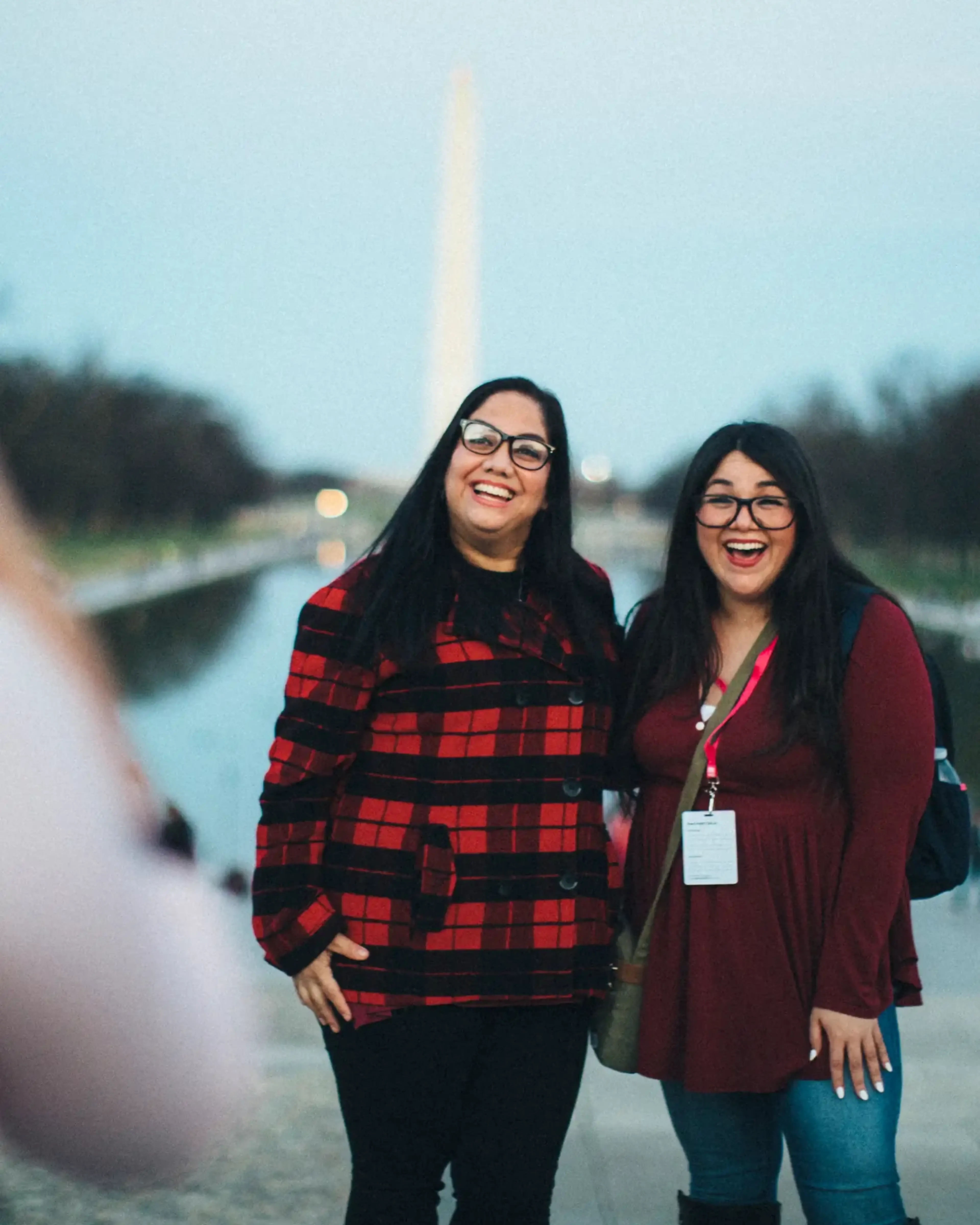 Two teachers taking a photo in front of the Washington Monument