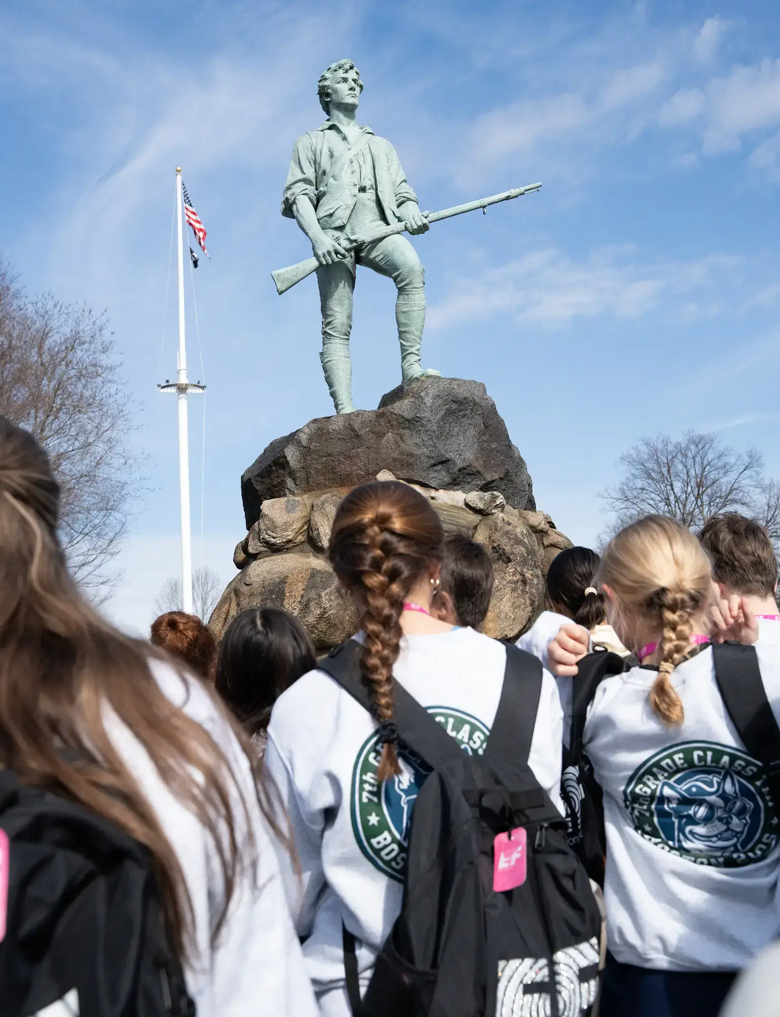 Students looking at statue in Boston, MA