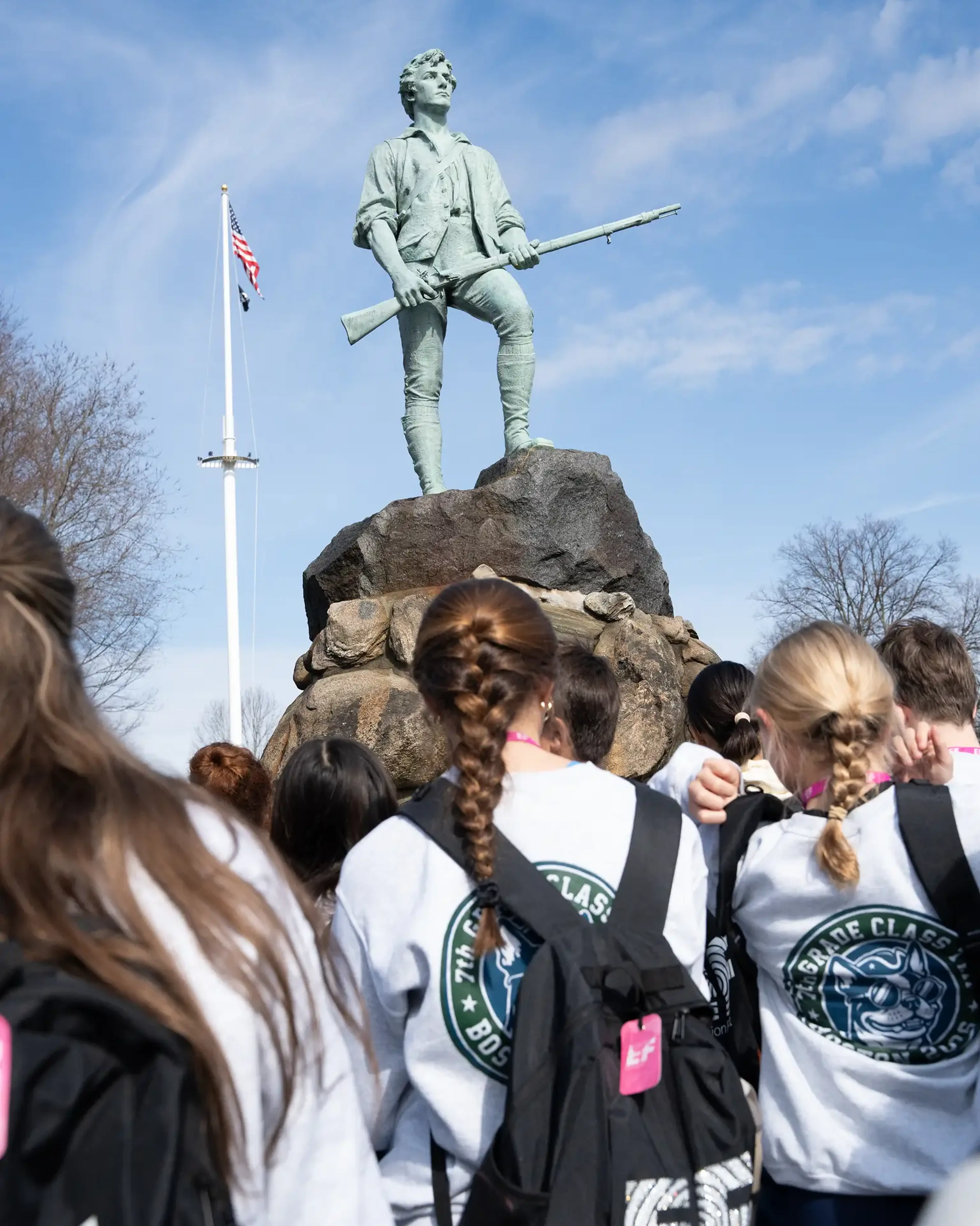 Students looking at statue in Boston, MA