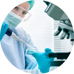 person working in a lab with petri dish