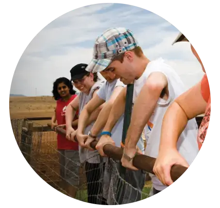 student group working on a fence