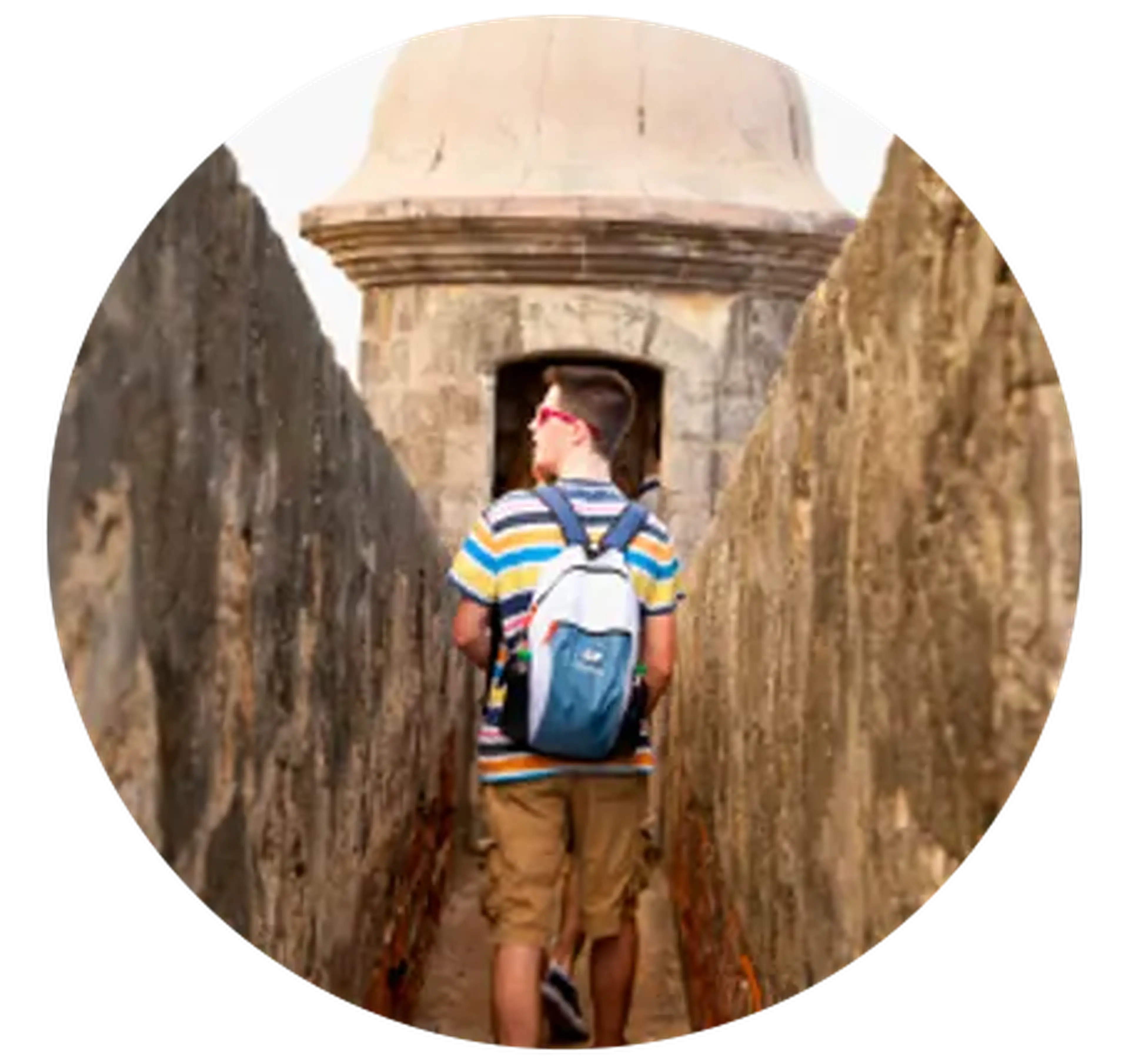 student walking along wall