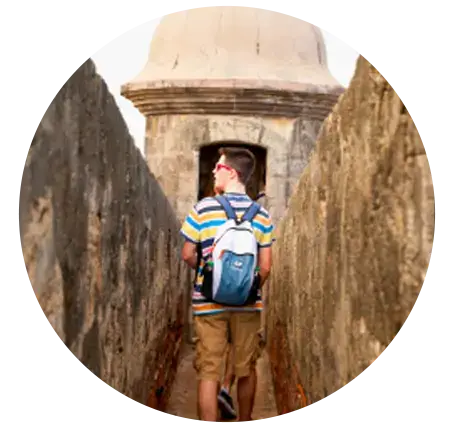 student walking along wall