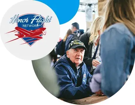 veteran with honor flight talking to a student