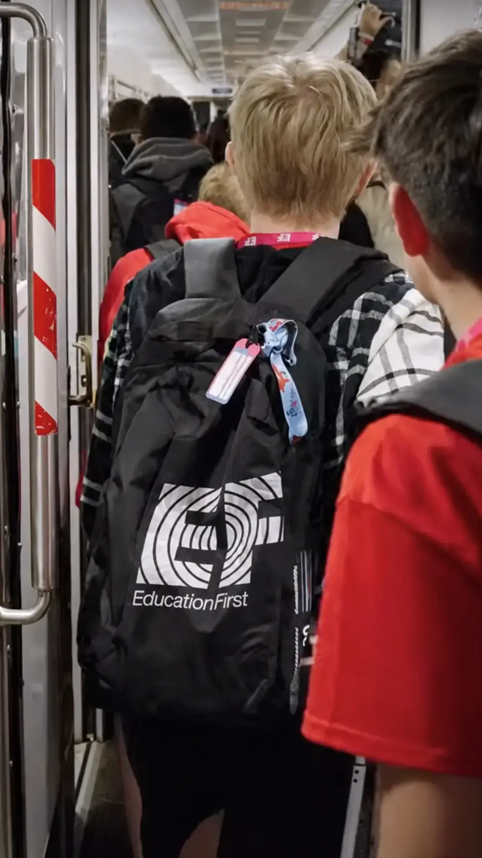 Traveler boarding train wearing EF backpack