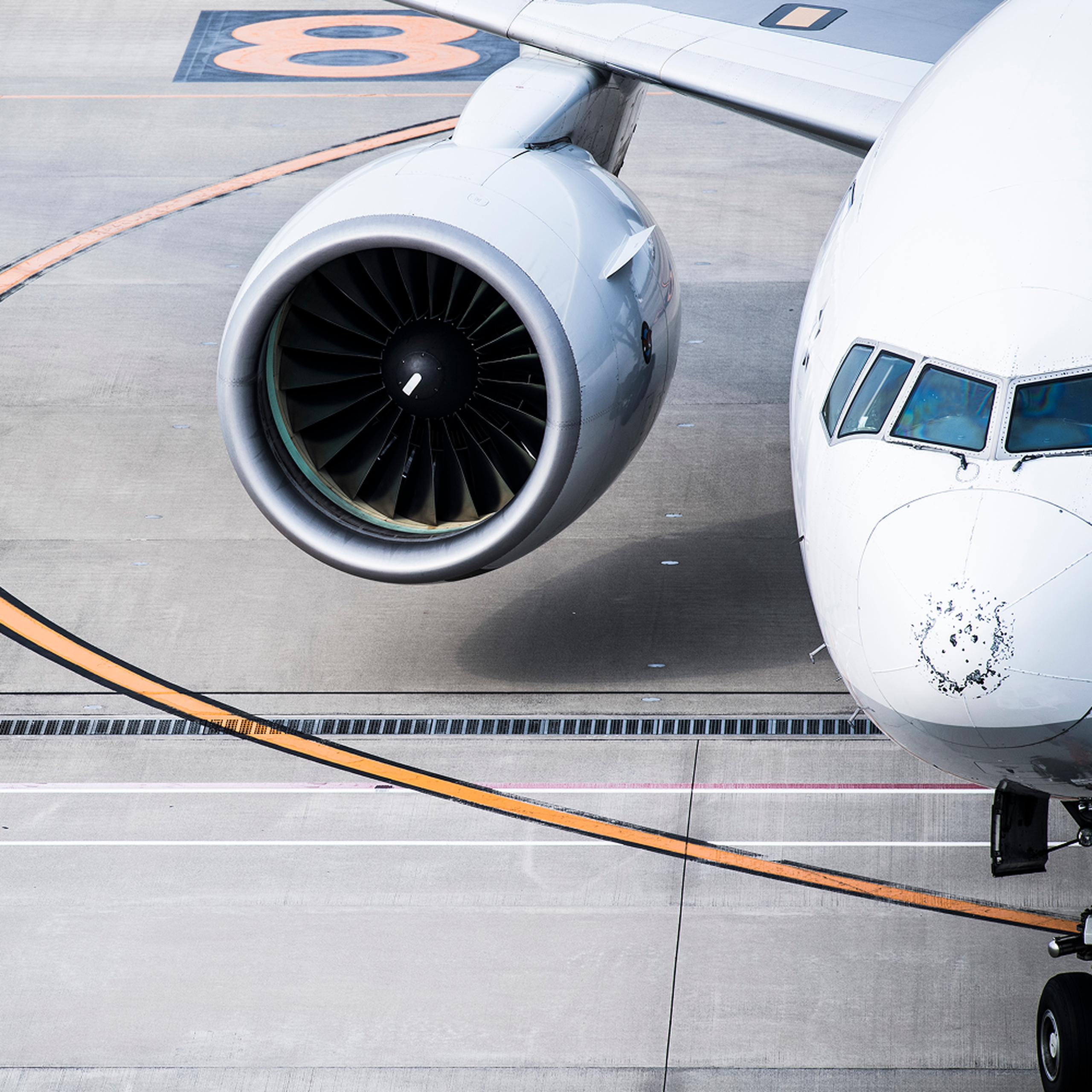 Close-up of a jet engine and part of an airplane on a tarmac