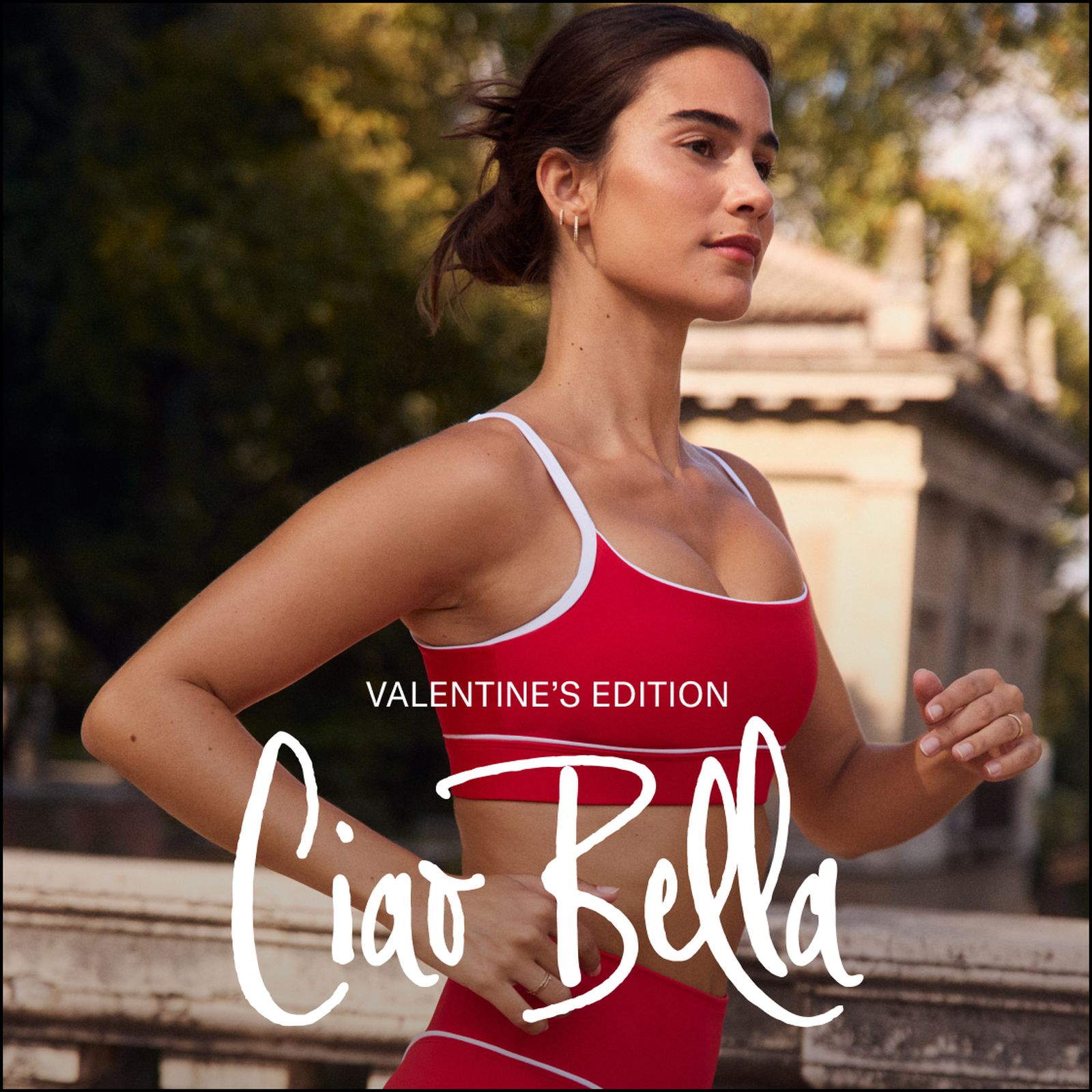 A woman in a red athletic outfit runs outdoors with "Ciao Bella, Valentine's Edition" text overlaid. Trees and a stone building are in the background.