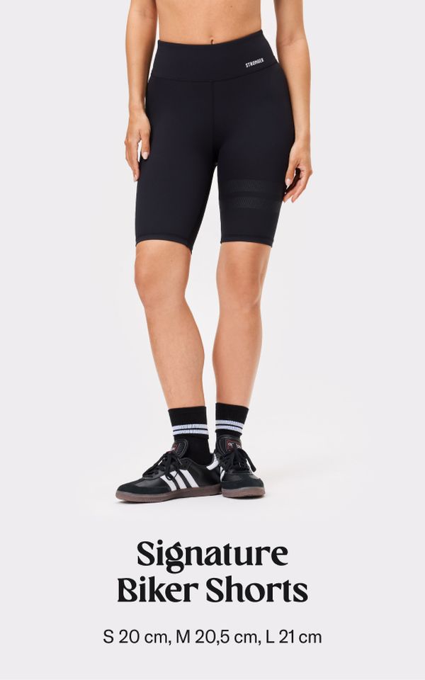 Person wearing black biker shorts and sneakers, labeled "Signature Biker Shorts." Available sizes: S, M, L with measurements.