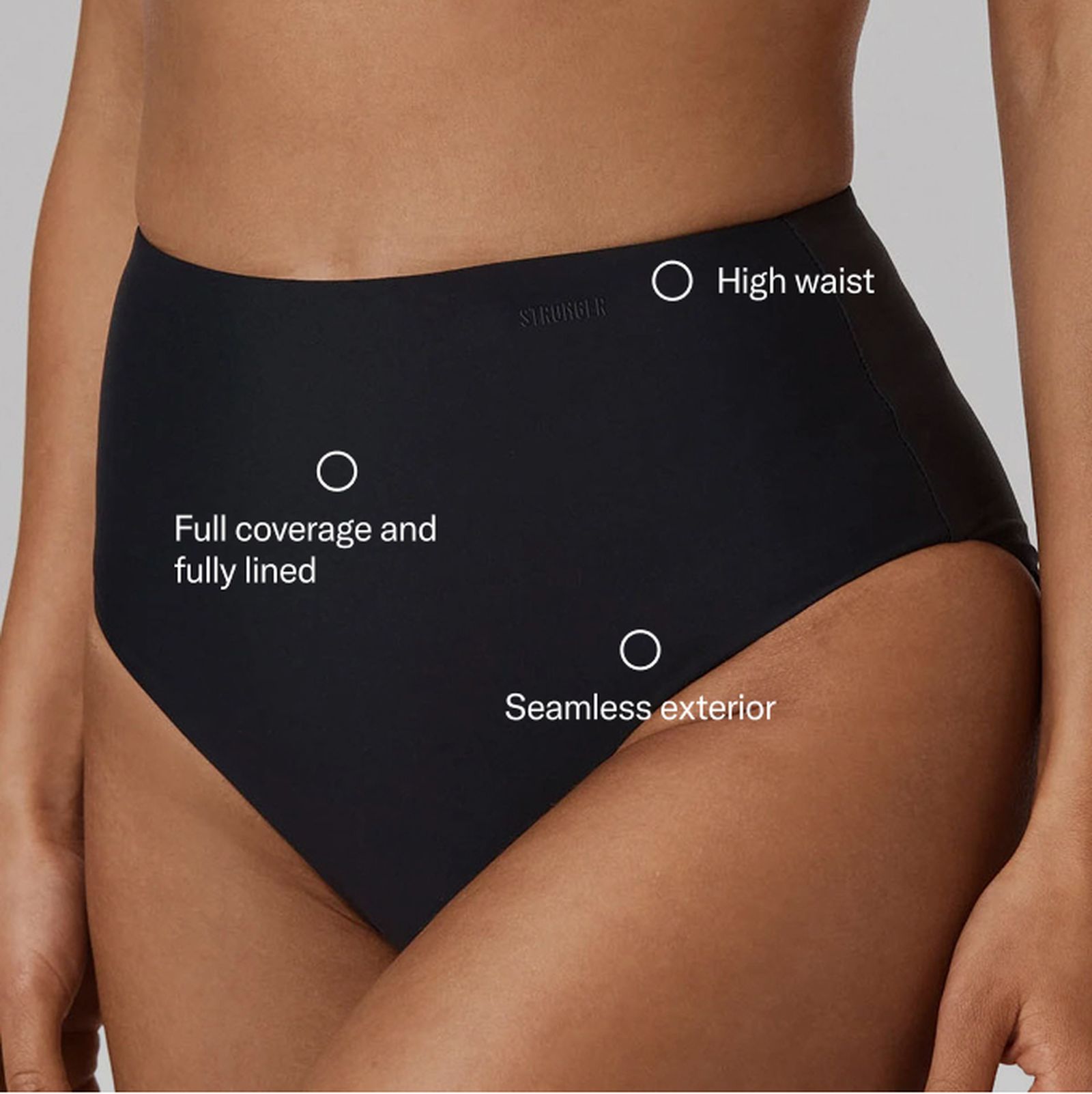 Close-up of a black high-waisted bikini bottom, featuring full coverage, fully lined, and seamless exterior on a model's midsection.