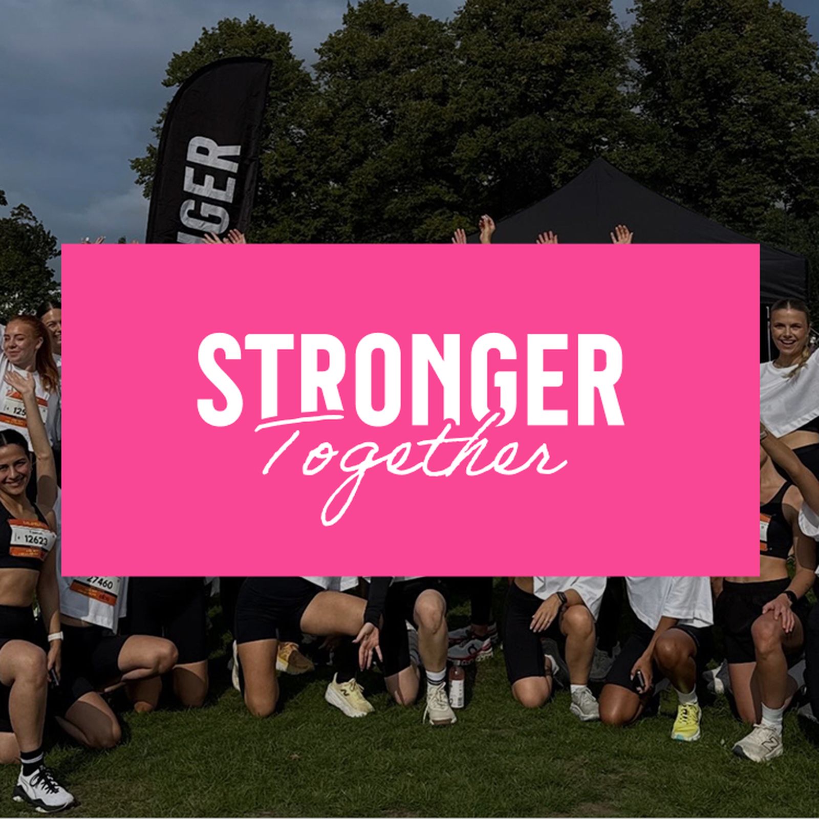Group photo of smiling people in sportswear outdoors. A pink banner with "STRONGER Together" is overlaid.