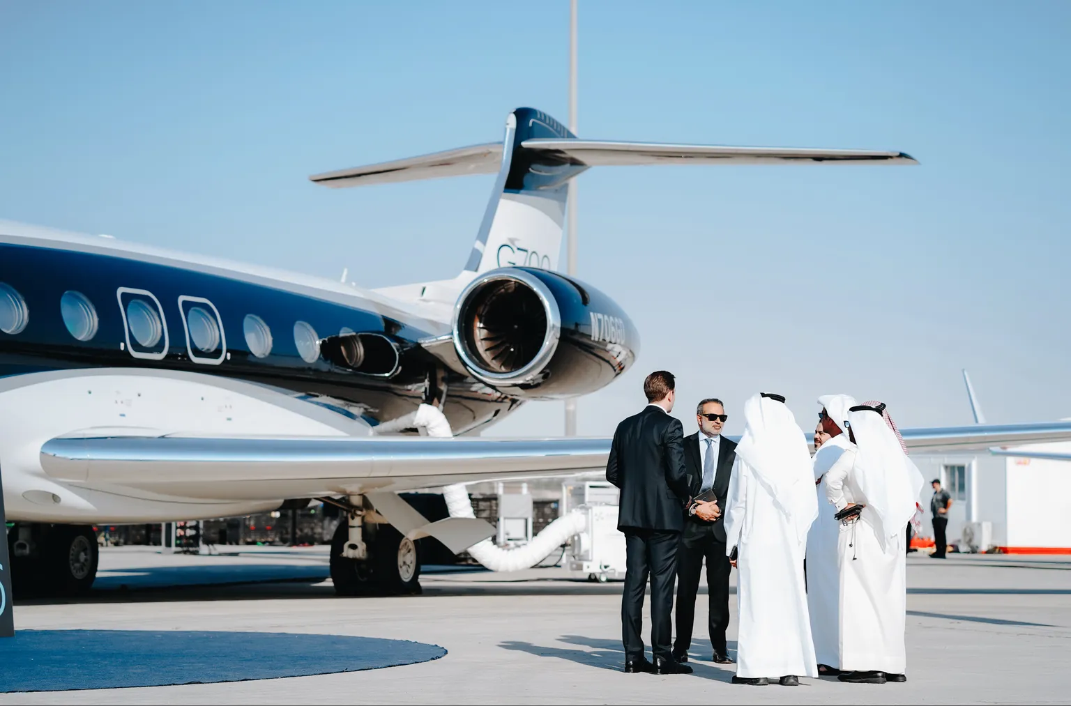 vip-guests-and-crew-standing-by-private-jet-on-runway