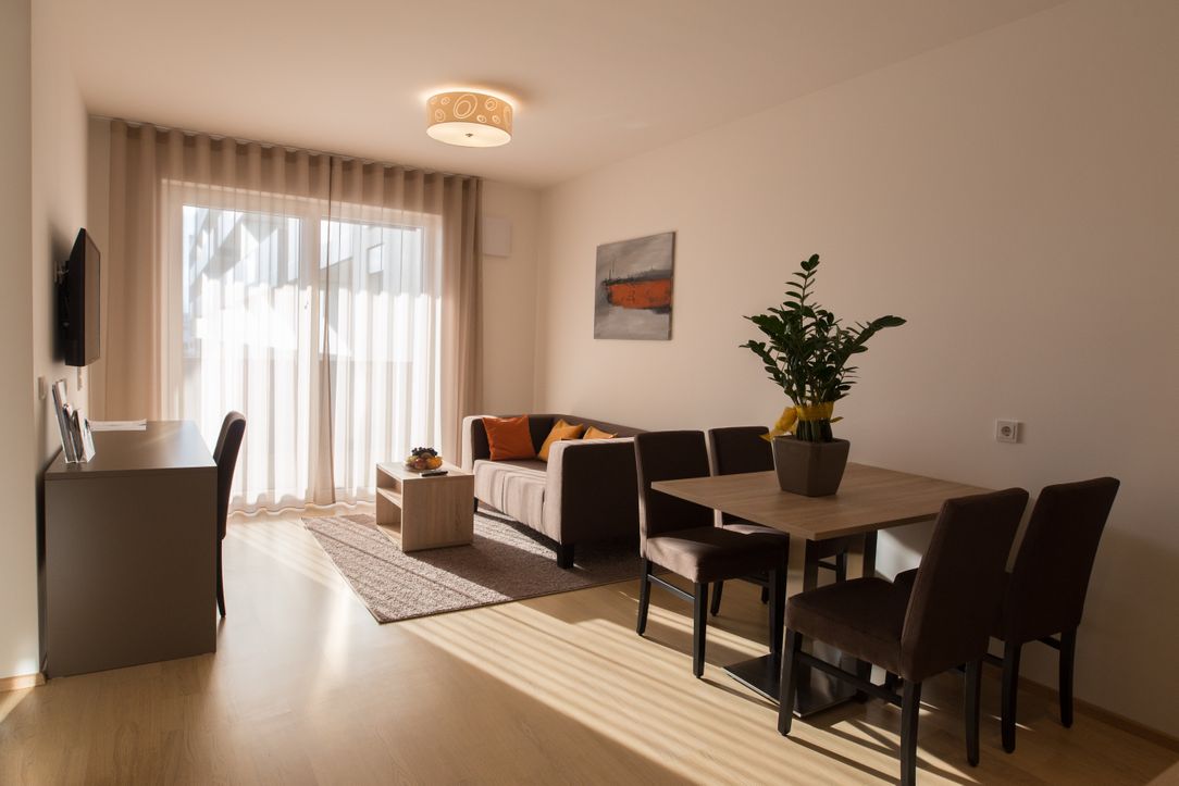 Wohnraum im Vitus Steyr mit Esstisch und Sofabereich.