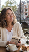 Vrouw na bovenooglidcorrectie aan een Amsterdams gracht-café