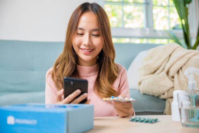 Woman scanning medication with smartphone