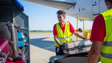 unloading luggage from air craft