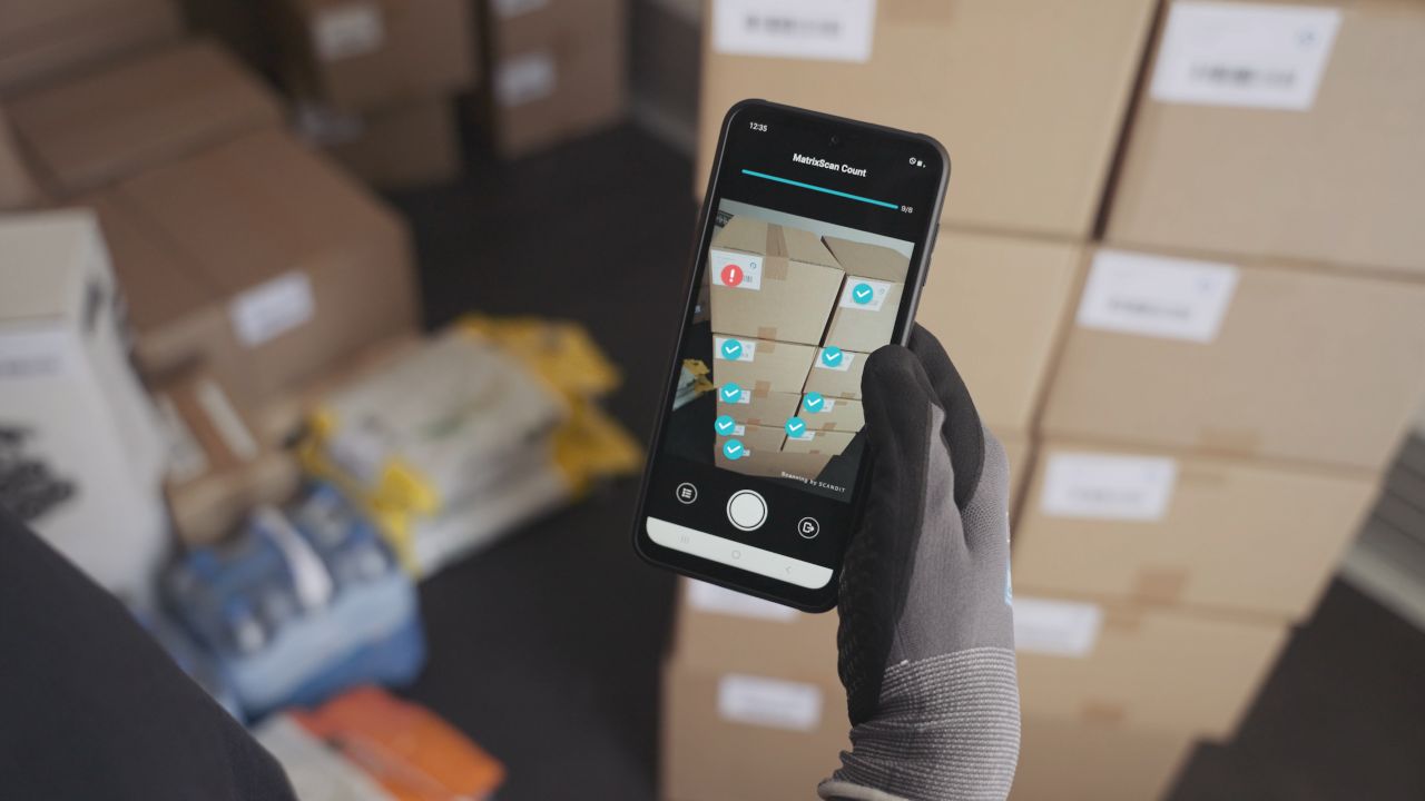 Data democratization tool being used on a smartphone to identify incorrect packages in a delivery