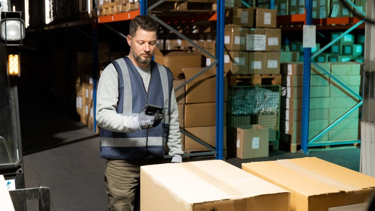 Worker managing inventory in a warehouse