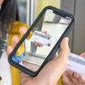 a delivery driver scanning a customer's id to verify age during an alcohol delivery