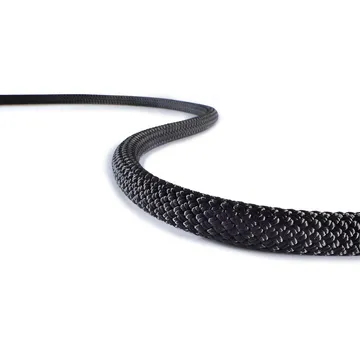 Black braided synthetic rope curved on white surface