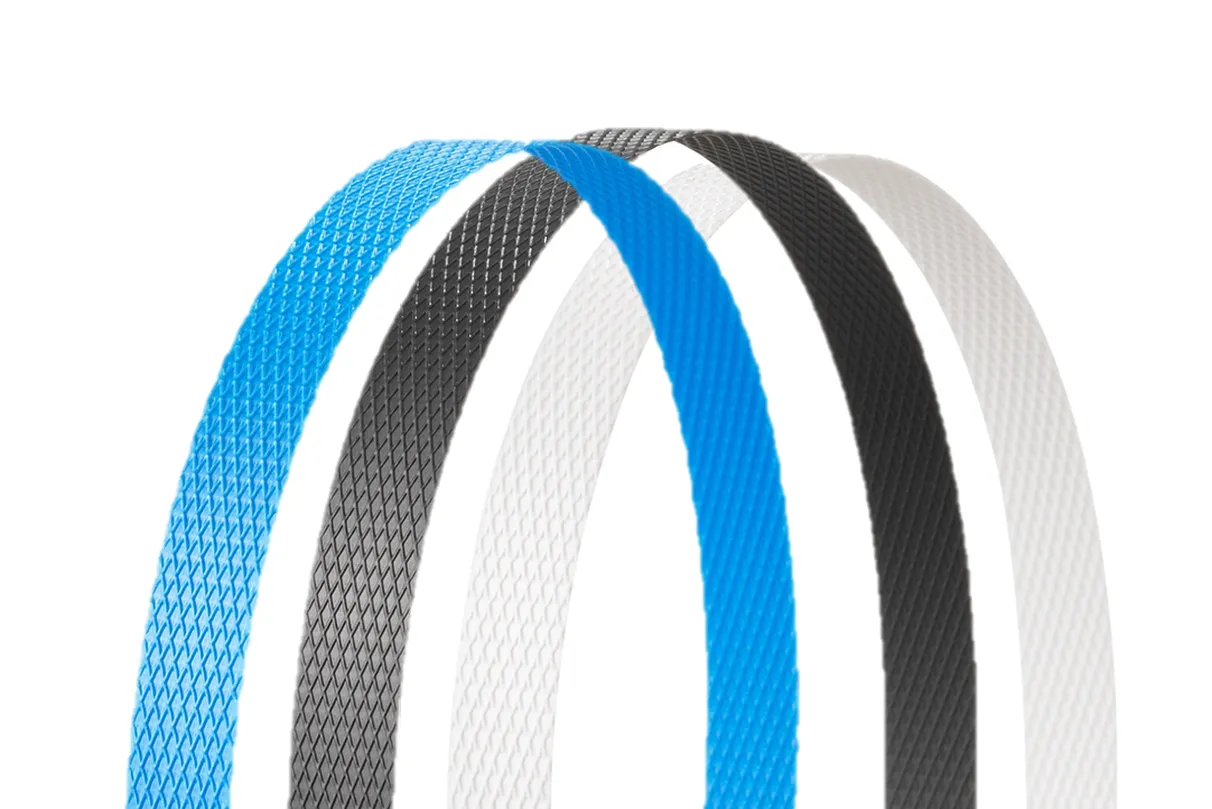 Three certified PP strapping products  Three textured plastic straps in blue, black, and white, standing vertically against a white background.