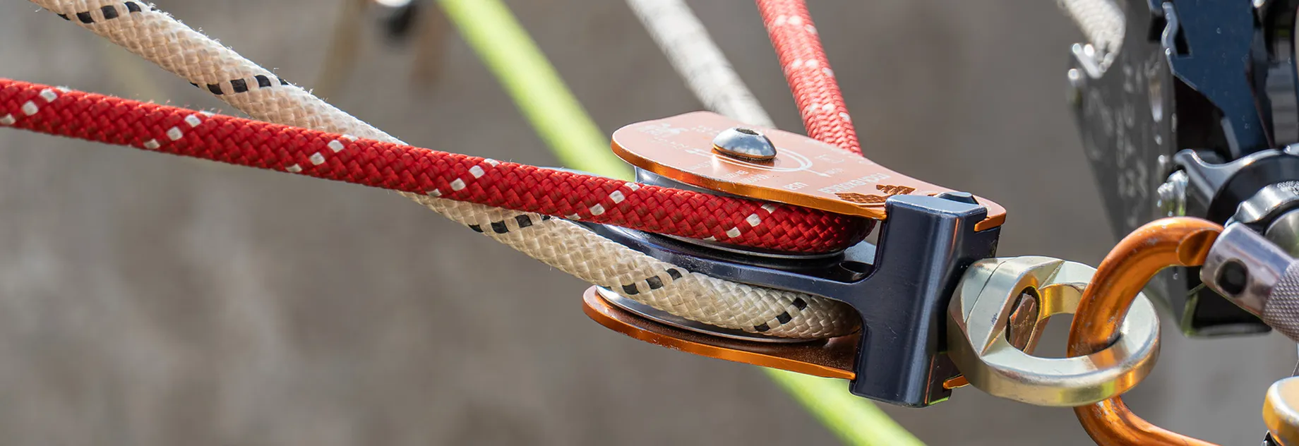 Red and white rope running through a double pulley