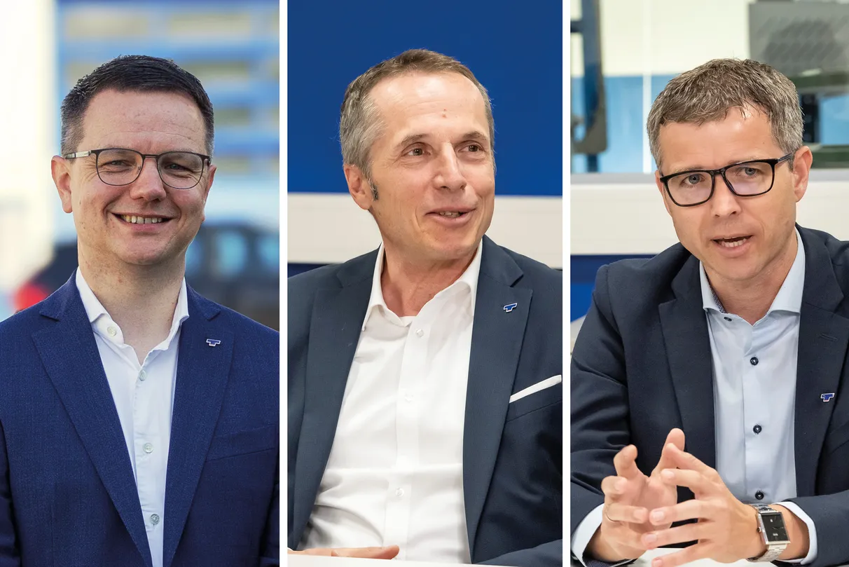Three men in business attire engaged in a discussion at a conference table, each in a separate panel.