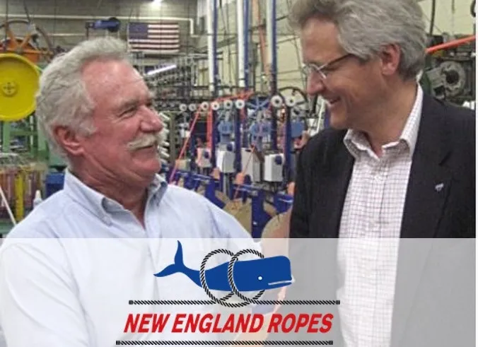 Two men shaking hands in an industrial setting with machinery in the background, featuring the New England Ropes logo.